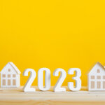 yellow background with houses and 2023 sign