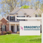 nice house with green grass with a sign that reads Dragonfly investment and development
