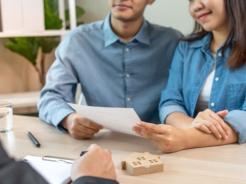Real estate agent and buyer reviewing a home inspection report