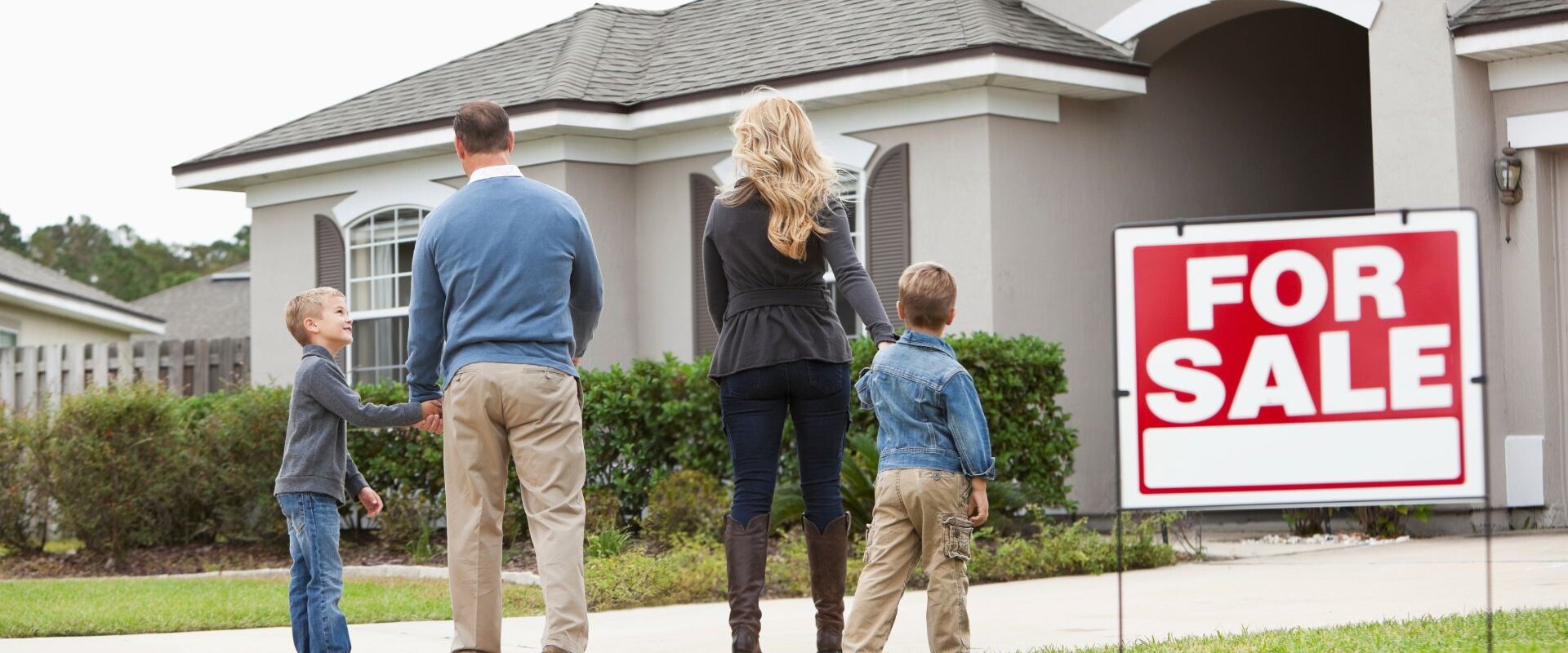 A family walking towards a house