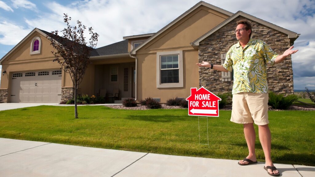 A man with a confused look with a house in the background