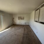 Quick Home Offers bought this CA home with mold. Mold is visible in the living room wall.
