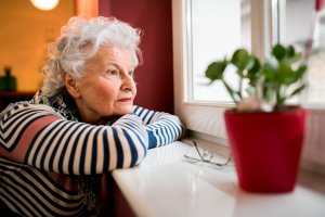 woman looks out of window