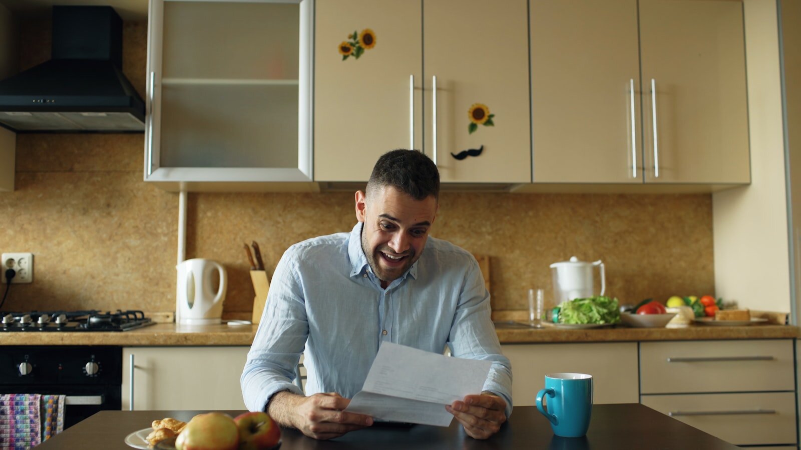 Hamilton homeowner reviewing financial documents at kitchen table — selling during financial hardship