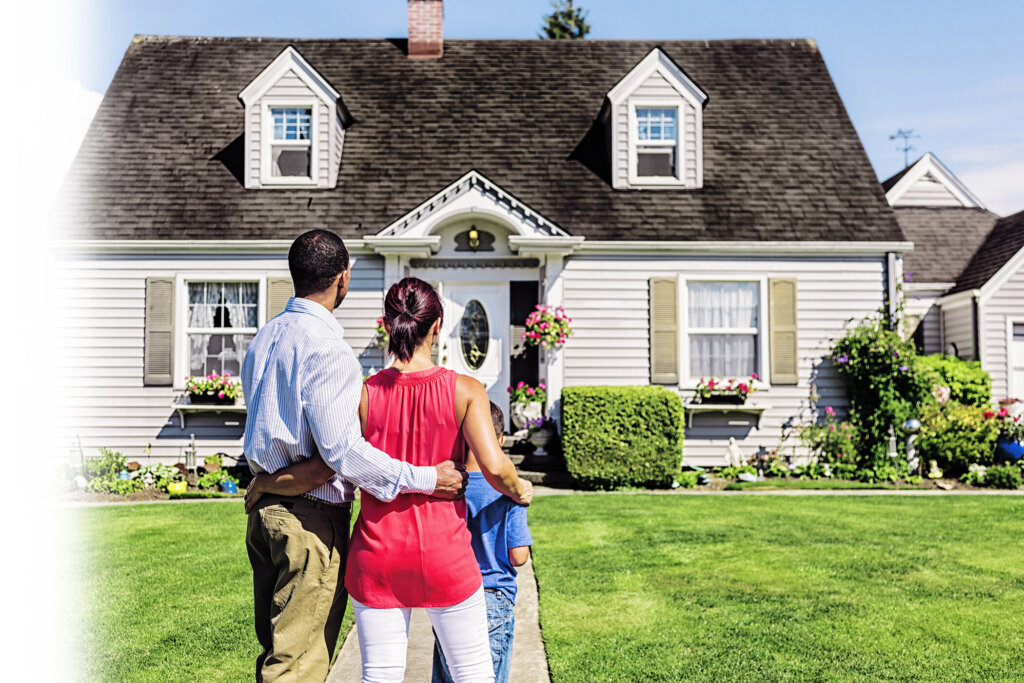 Happy Young Family Admiring Home
