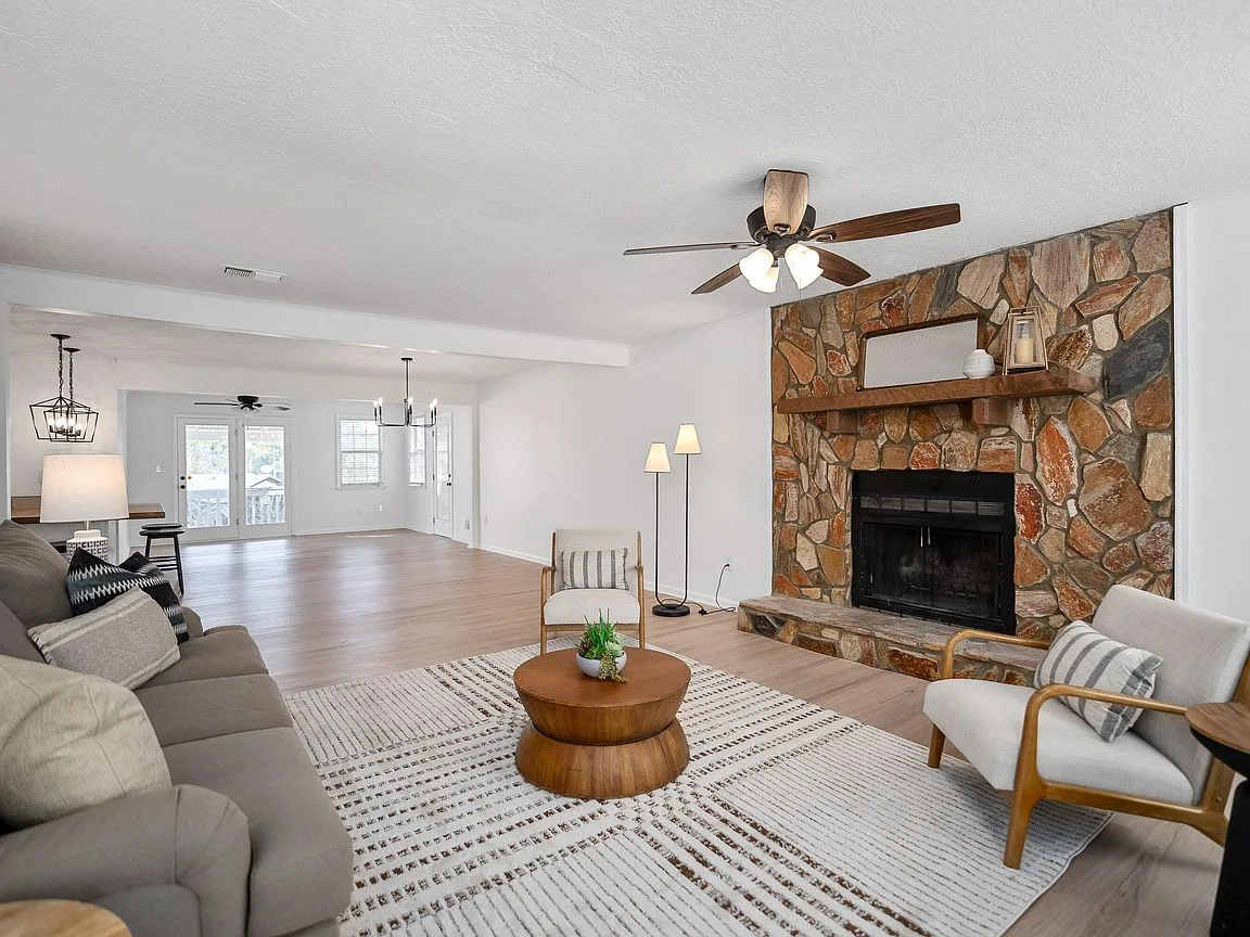 Renovated living room with stone fireplace in a Hephzibah, GA ranch home