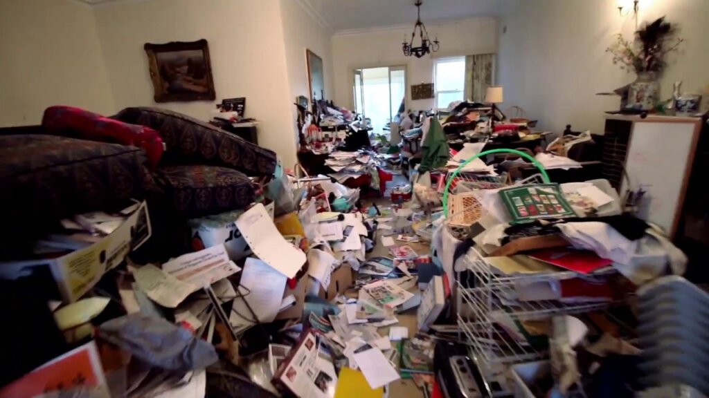 Picture of a hoarder House. Junk is covering the whole floor in the living room and the dining room.
