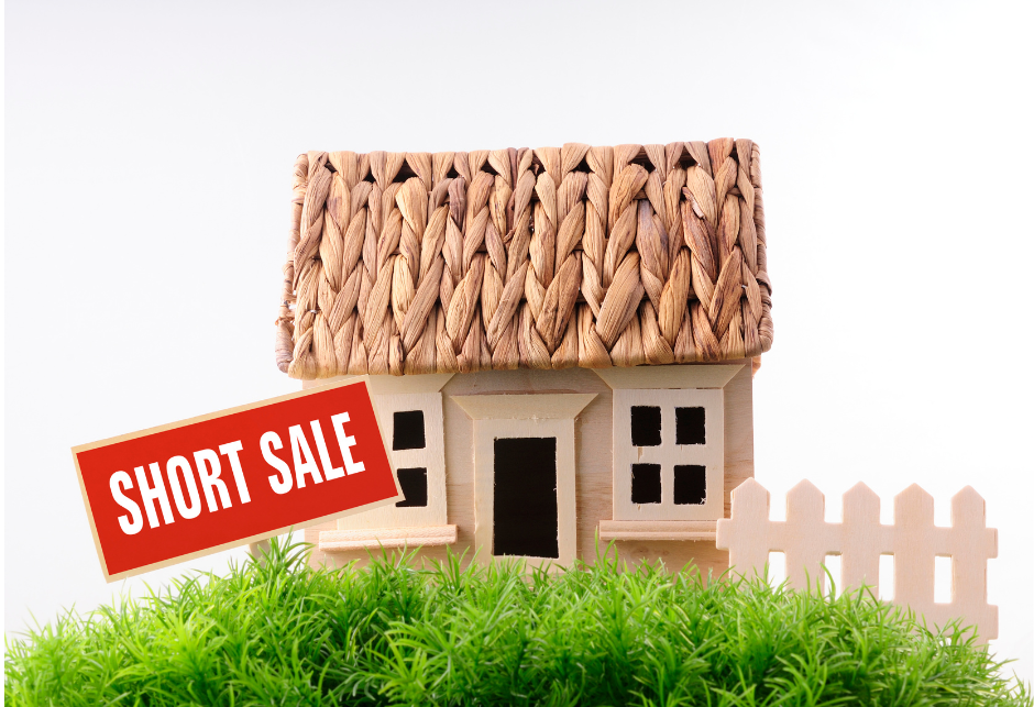 model house with a sign in the front yard that says short sale