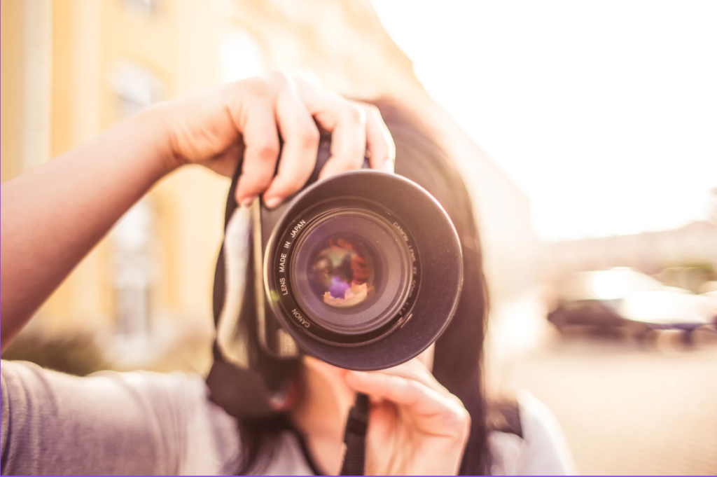 Professional photographer taking a picture of real estate for a listing with a nice camera.