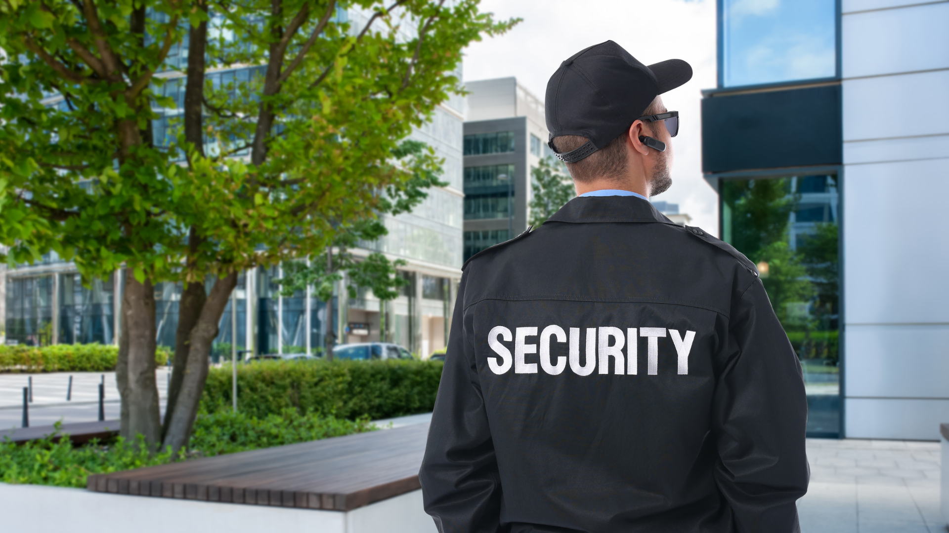 Security guard monitoring entrance at a gated residential community.