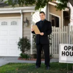 Real estate agent standing outside a residential property with an open house sign in the front yard.