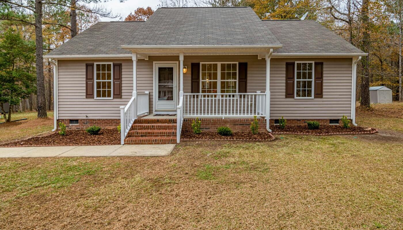 One story home with brown siding in suburbs of North Carolina for sale. Owners selling home as-is with no repairs.