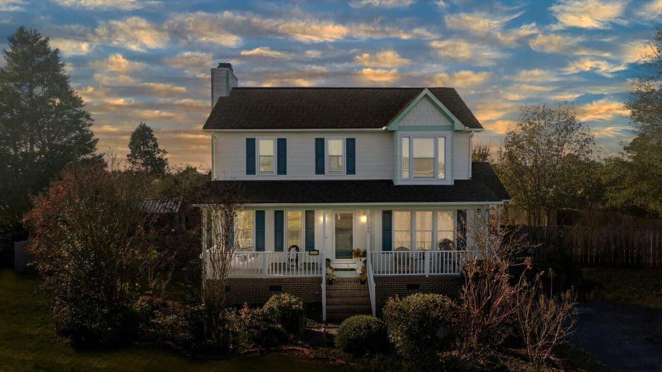 White home with blue shutters near Asheville, NC. Selling home as-is in mountains of North Carolina.