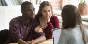Realtor with couple going over offers