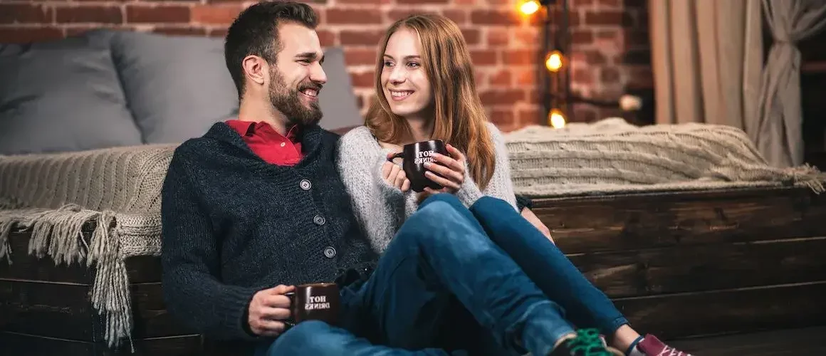 Happy white couple sitting indoors