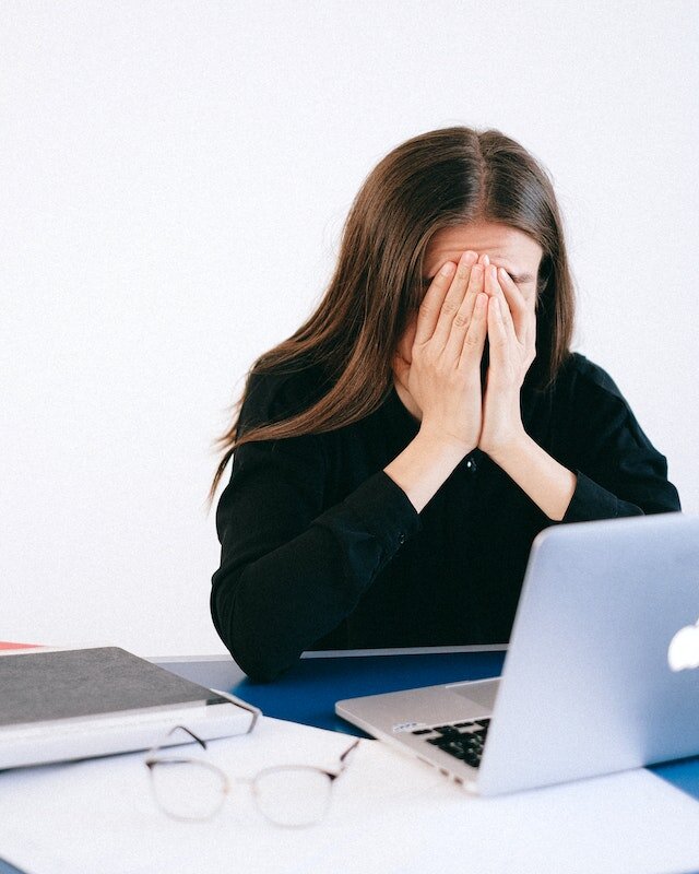 woman looking worried at past due bills