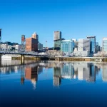downtown Portland skyline with bridge and waterfront reflection