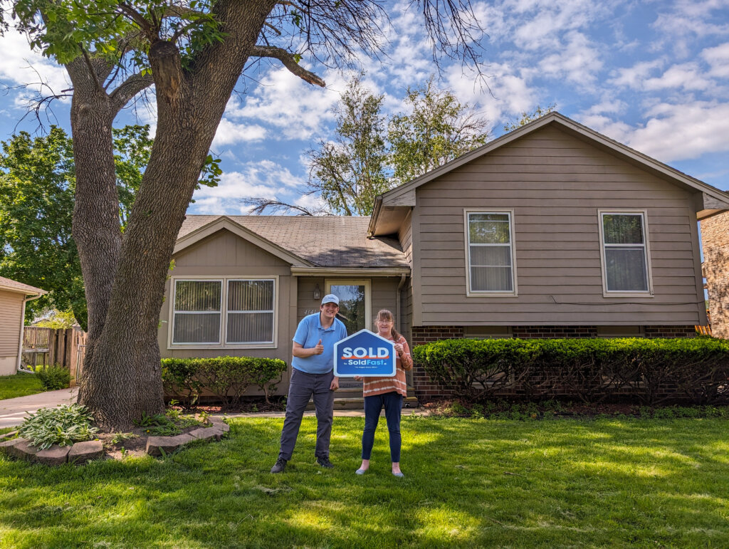 soldfast real estate agent with happy seller who sold her house