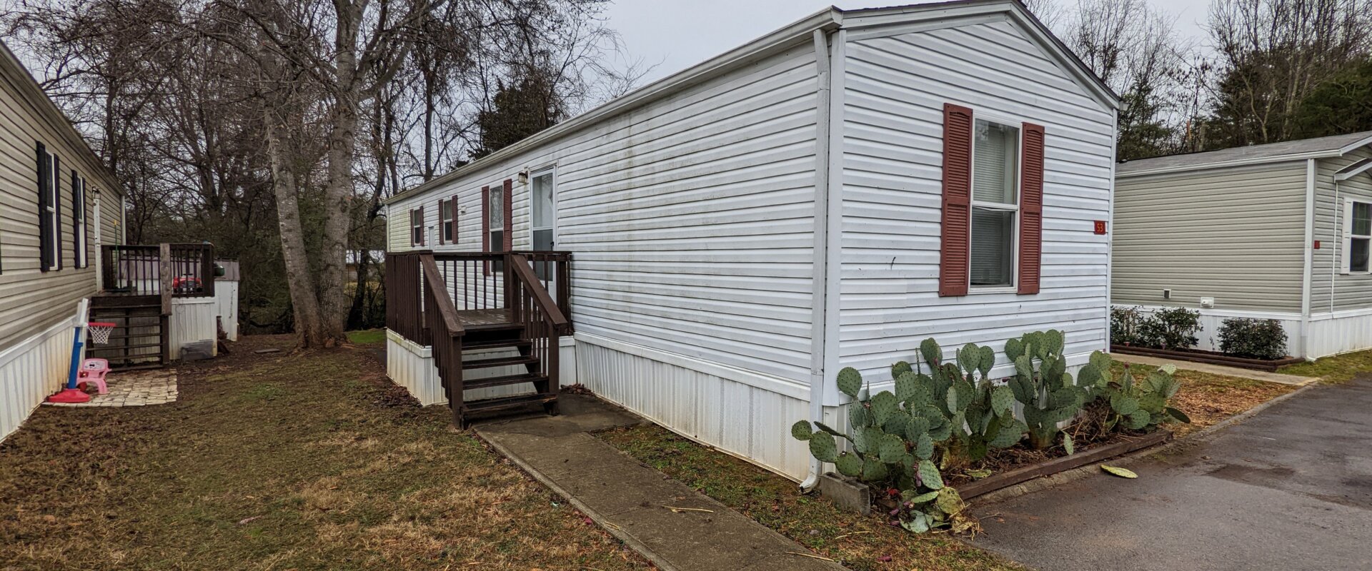 white singlewide mobile home located in Grand Oaks Mobile Home Park Powell, TN knox county