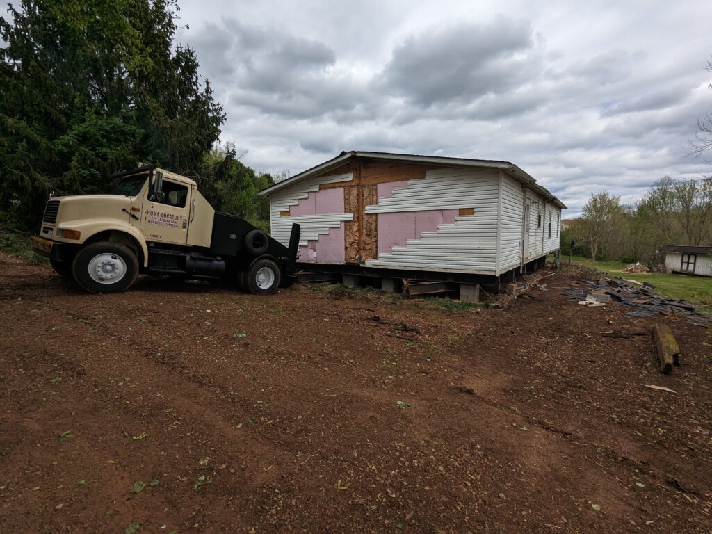 mobile home toter hooked to doublewide mobile home