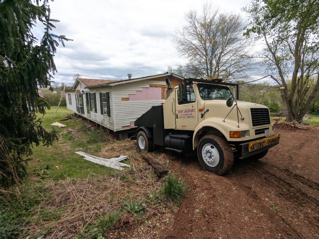 mobile home toter hooked to doublewide mobile home