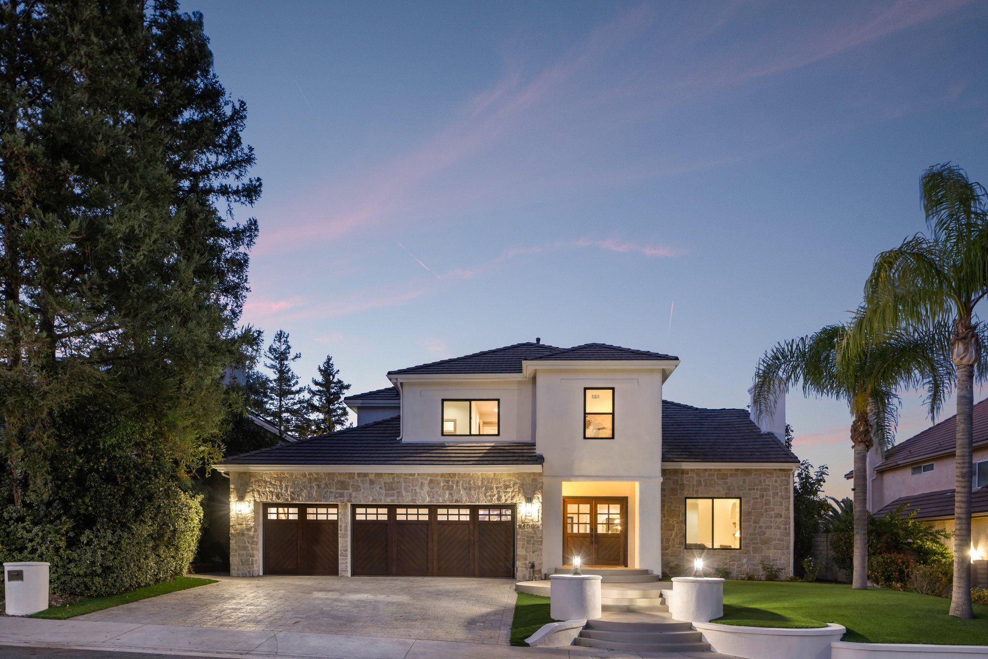 Renovated stone facade home at twilight at 24005 Clarington Dr in West Hills, purchased and renovated by Abe The Home Buyer