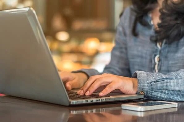 Women at a laptop entering data.