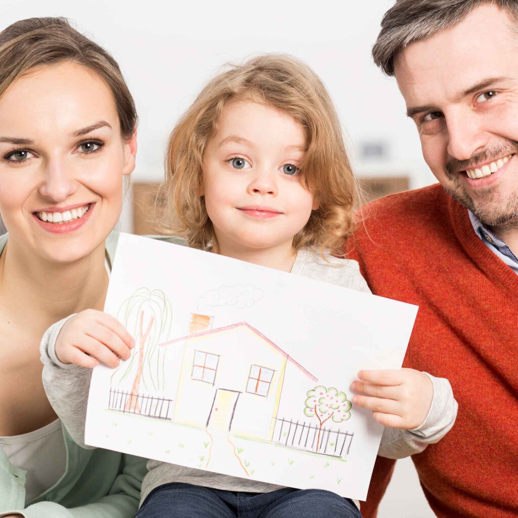Planning for housing - child holding drawing of a house