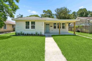 After: 325 N Bengal, Metairie — white-brick bungalow with sage front door renovated by Bertucci Investment Group cash home buyer
