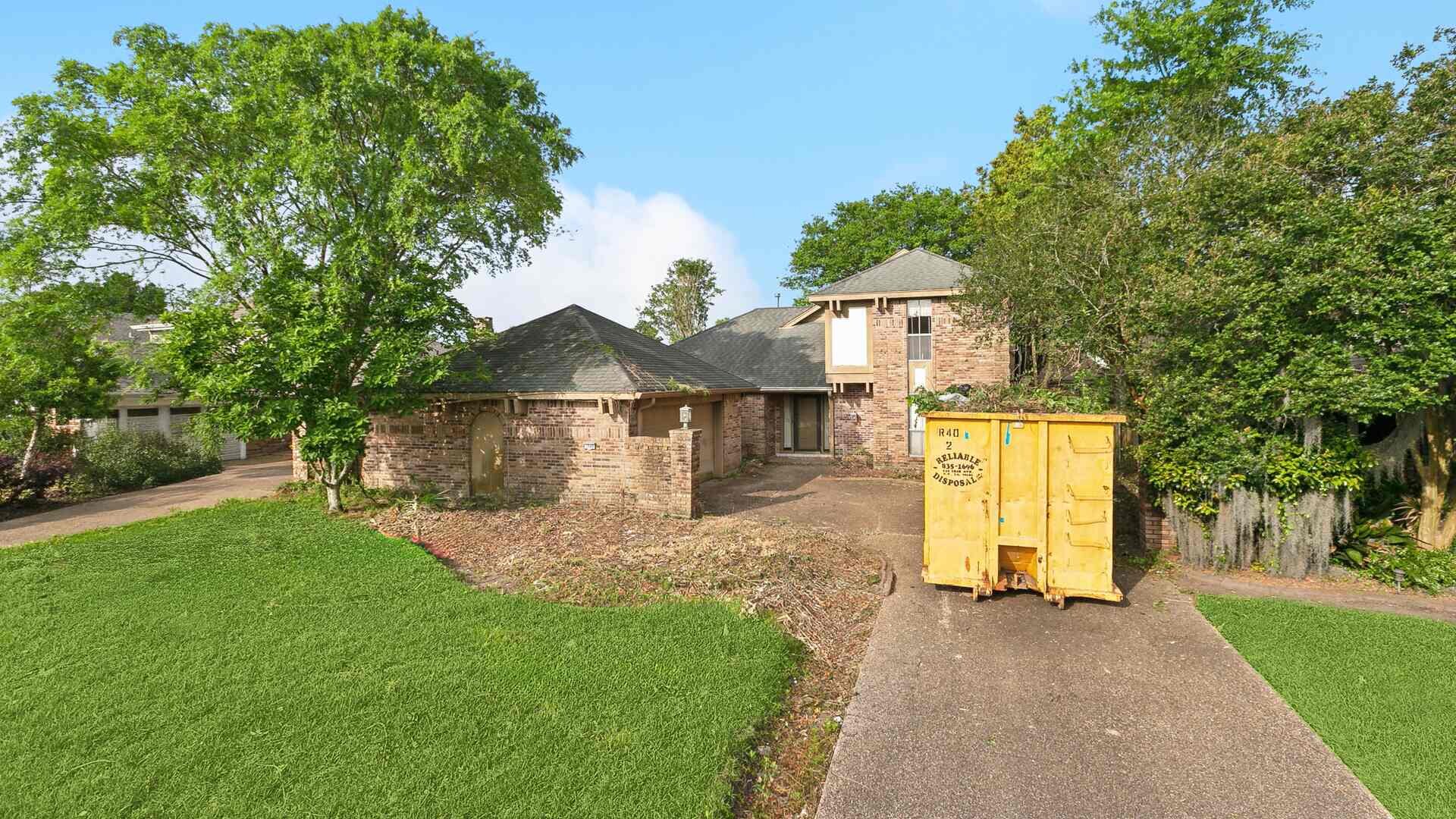 Before: 3949 Lennox, Metairie — brick two-story front elevation mid-renovation, a Bertucci Investment Group cash home buyer acquisition