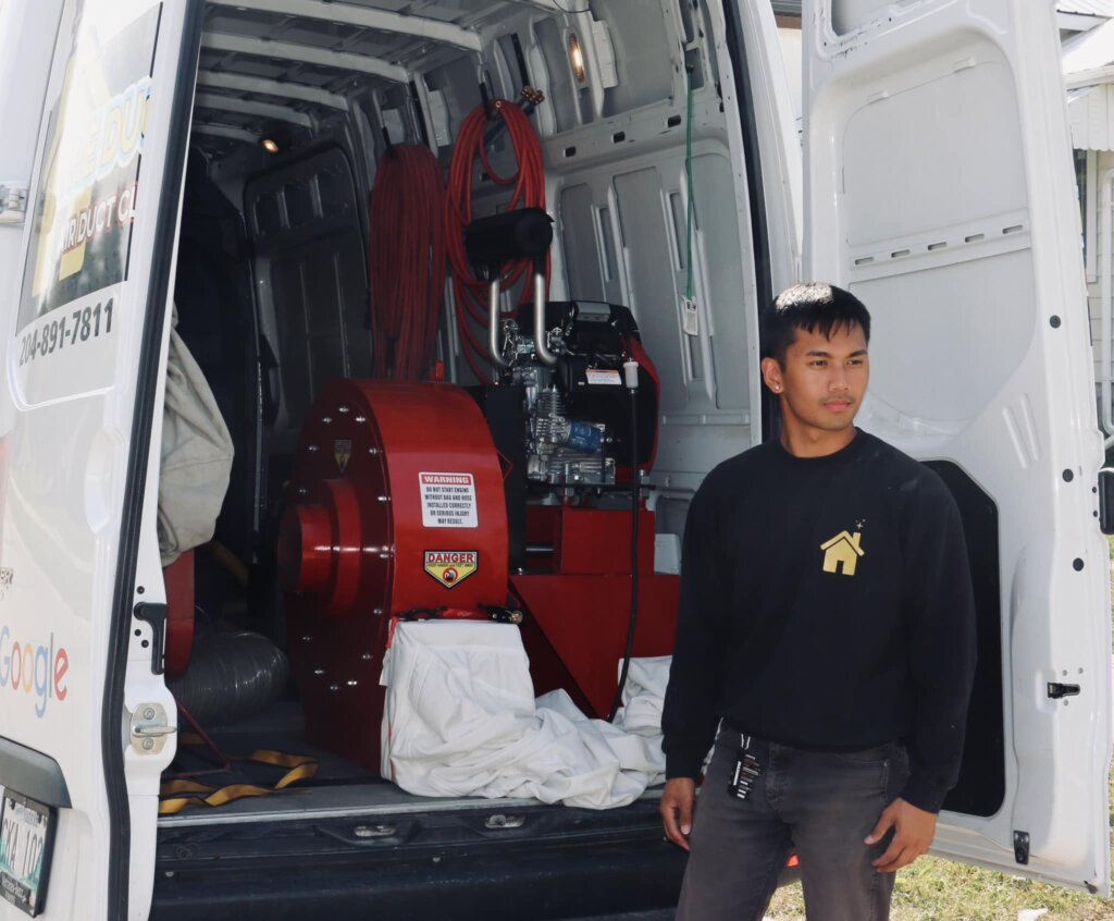 A man standing in front of a van from Air Duct cleaning company in calgary
