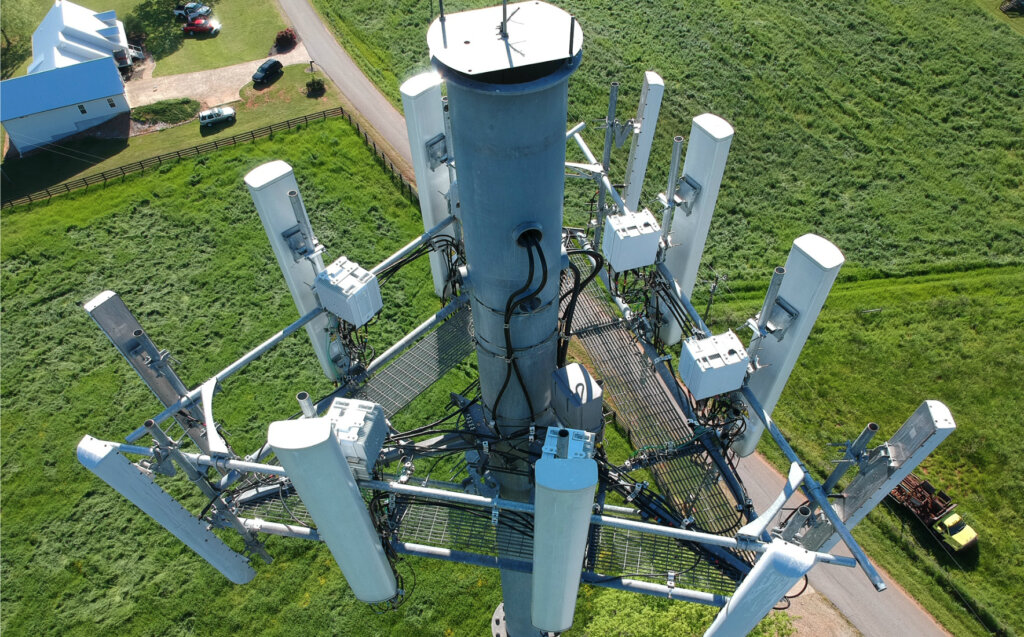 Drone image of monopole cell tower on our website page instructing property owners to contact us for help with a cell tower lease buyout.