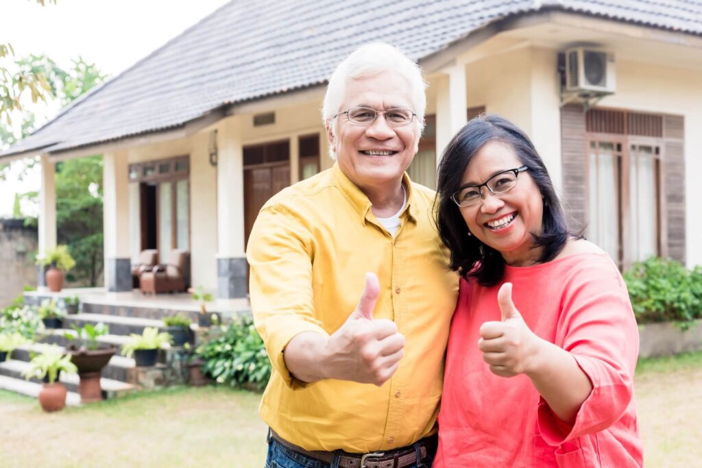 smiling middle aged couple in backyard of home