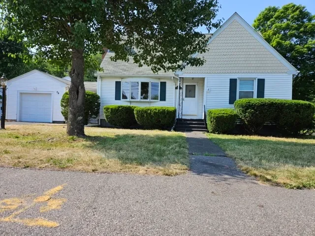 Single-family Cape Cod style inherited house in Norton MA needing landscaping and exterior updates.