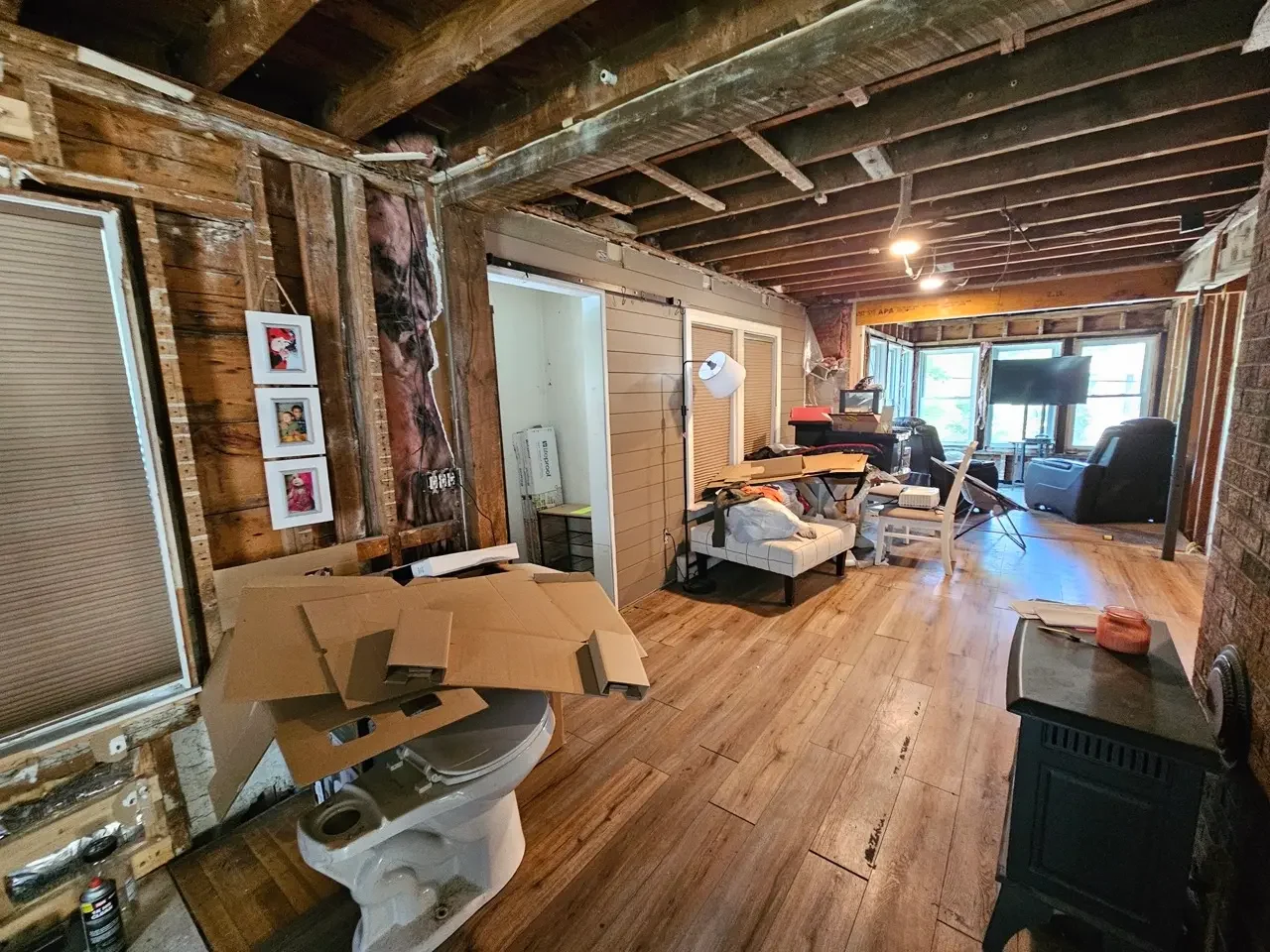 Home interior featuring exposed framing, deferred maintenance, and renovation materials