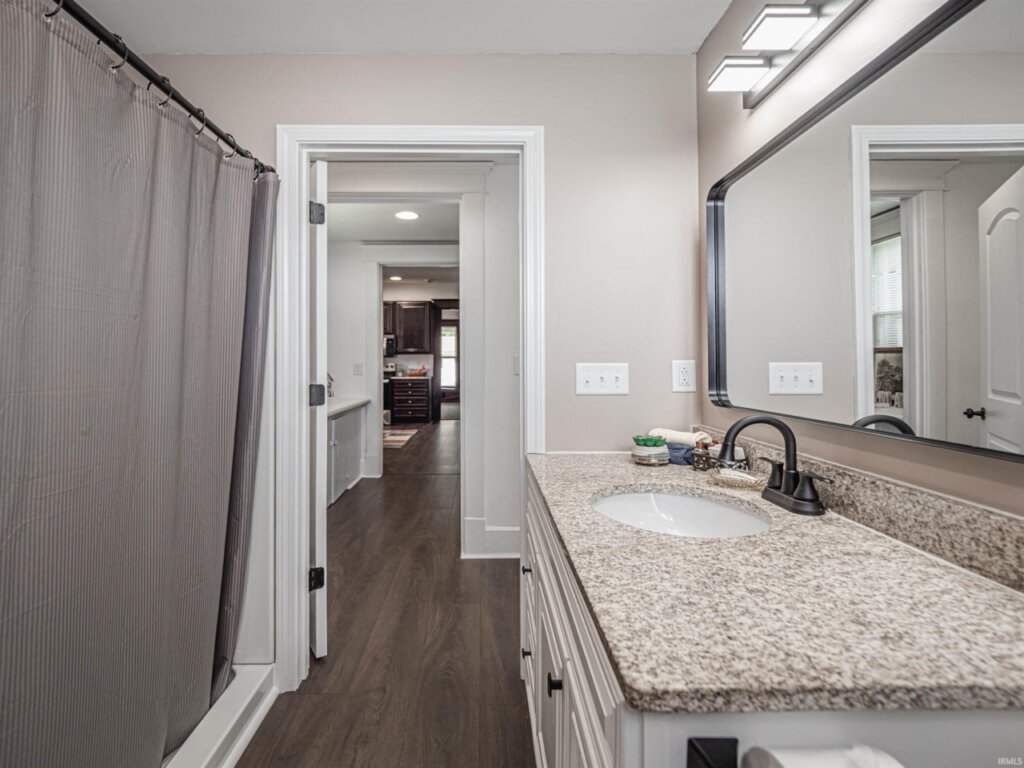 Updated bathroom in Owensville Home. The sink is to the right and the shower is to the left.