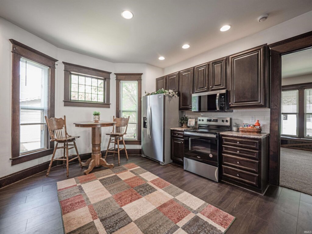 Newly remodeled kitchen with a small eat-in-kitchen table and updated appliances.