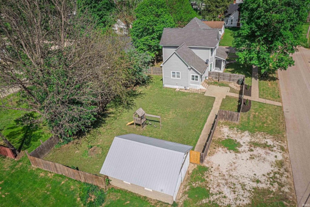 Aerial view of a stunning two-story Owensville home and its backyard.