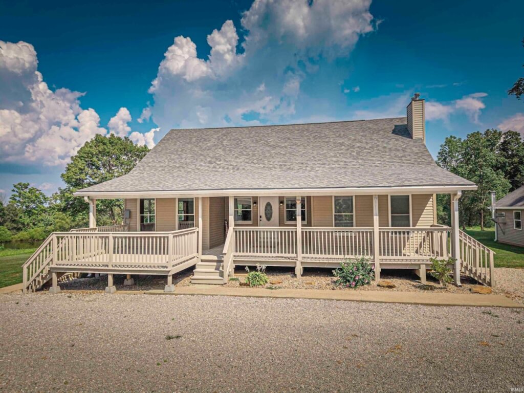 Beautiful home in Holland, Indiana with a covered porch and blue, sunny skies.