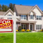 Newly sold spacious suburban Ohio home in spring with a vibrant green lawn, showcasing a bright 'For Sold' sign, symbolizing a successful real estate transaction in a seller's market.