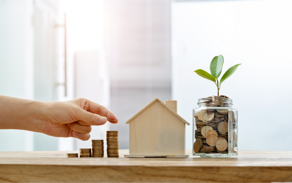Saving money on home sale in Cincinnati with coin stack and house model