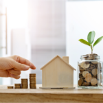 Saving money on home sale in Cincinnati with coin stack and house model