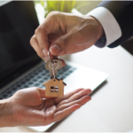 Real estate agent handing over new house keys to homeowner after closing in Ohio