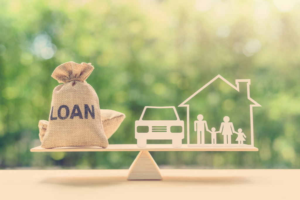 Balance scale with a house and car on one side and a loan bag on the other, representing mortgage and loan options for Ohio homeowners.