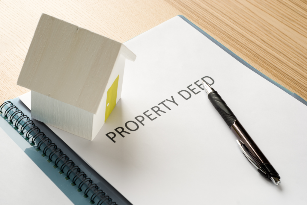 Property Deed and Pen on Table Indicating Estate Transfer Steps in Ohio