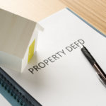Property Deed and Pen on Table Indicating Estate Transfer Steps in Ohio