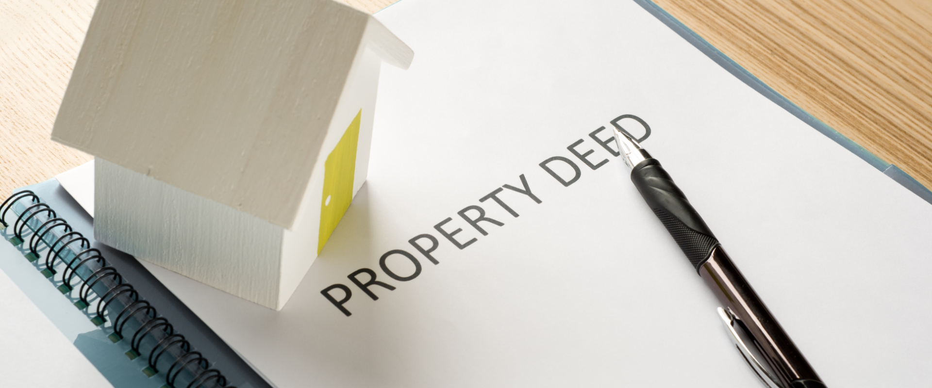 Property Deed and Pen on Table Indicating Estate Transfer Steps in Ohio