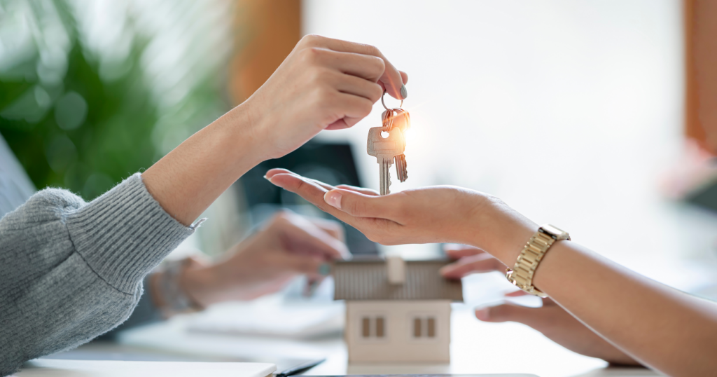 Family member handing keys over to new homeowner, symbolizing property inheritance in Ohio.