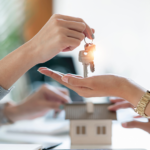 Family member handing keys over to new homeowner, symbolizing property inheritance in Ohio.