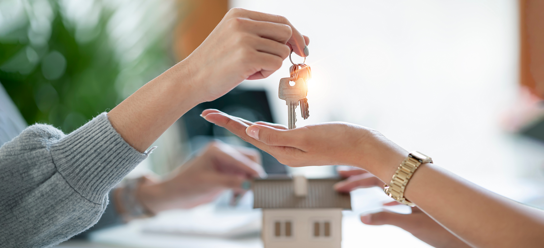 Family member handing keys over to new homeowner, symbolizing property inheritance in Ohio.